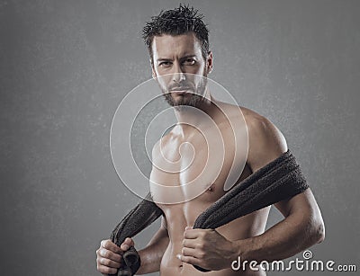 Cool athletic man posing with towel Stock Photo