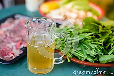 Cool beer in the glass and raw materials for cooking. Stock Photo