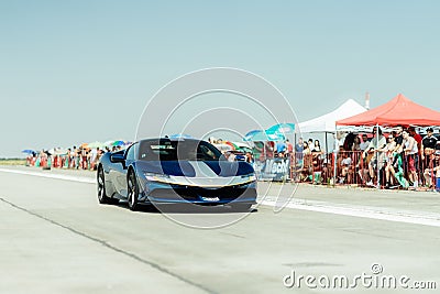 Cool blue car and a group of people at a Drag Racing event at the Arad International Airport Editorial Stock Photo
