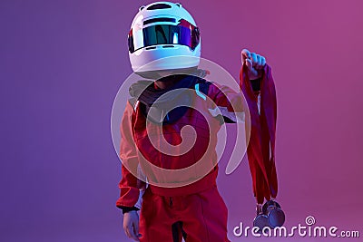 Cool boy child racer in helmet with medals, standing in neon light. Kart racing school poster. Competition announcement Stock Photo