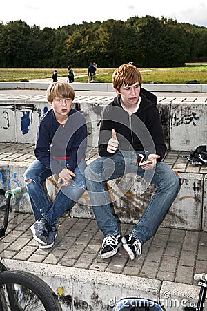 Cool boys sitting on a stone Stock Photo