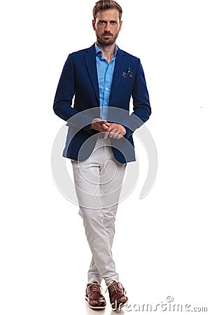 Cool elegant man standing with legs crossed Stock Photo