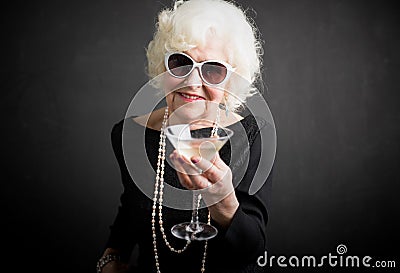 Cool grandma havinga a drink Stock Photo