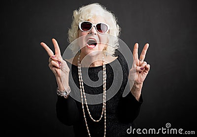 Cool grandmother showing peace sign Stock Photo