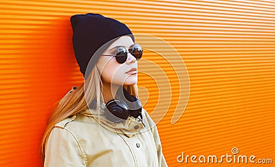 Cool hipster girl wearing a black hat and headphones Stock Photo