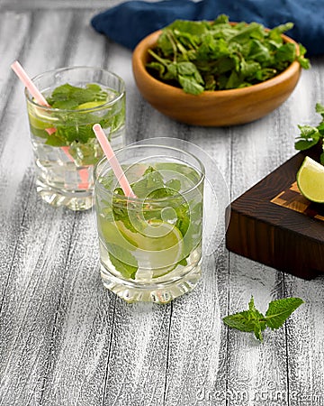 Cool lemonade with mint and lime and ice in glass cups Stock Photo