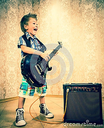 Cool little boy posing with electric guitar. Stock Photo