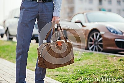 Cool man beautiful model outdoors, city style fashion. A handsome man model walking in the city center next to some cars Stock Photo