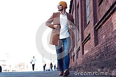 Cool man beautiful model outdoors, city style fashion. A handsome man model walking in the city center. Urban setting Stock Photo