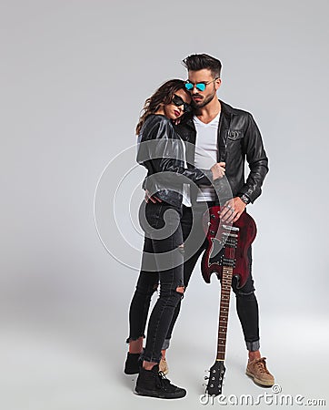 Cool rock and roll couple standing embraced, Stock Photo