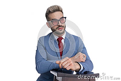 Cool serious businessman resting his arms on a chair Stock Photo