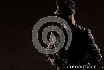Cool unshaved guy looking to side and posing in a fashion light Stock Photo