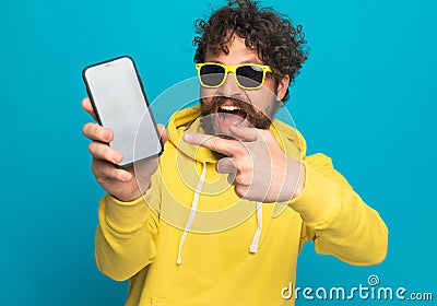 Cool unshaved man pointing finger to black empty screen Stock Photo