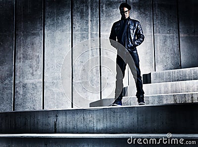 Cool urban african american man on distopic concrete steps Stock Photo