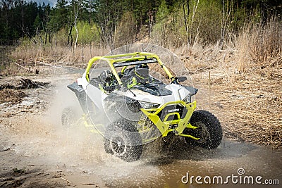 Cool view on hard ride UTV in muddy water Editorial Stock Photo