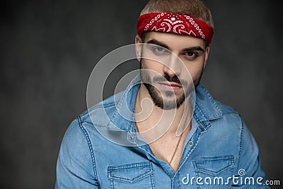 Cool young hipster wearing bandana and jeans shirt Stock Photo