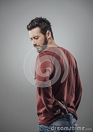 Cool young man holding a gun Stock Photo