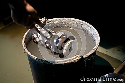 Cooling hot cast mold in water after metal melting Stock Photo