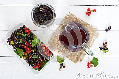 Cooling summer drink with berries - compote in a jug on a white Stock Photo