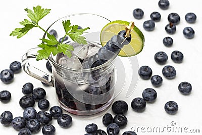 Cooling summer drink with blueberries and ice. Blueberries on the table Stock Photo