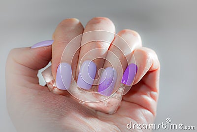 Cooling summer manicure with ice crystal. On the nails of lilac Stock Photo