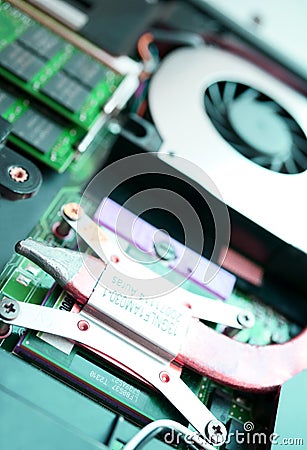 A cooling system of computer. A fan, cooler of central processing or the CPU cooler pc system unit.Electronic circuit board close Editorial Stock Photo