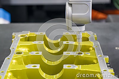 The Coordinate Measuring machine ,CMM probe measure dimension of the aluminium engine block parts . Stock Photo