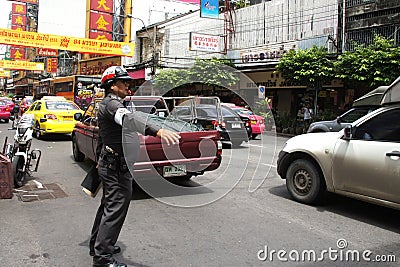 Cop commanding traffic in Chinatown, Bangkok Editorial Stock Photo