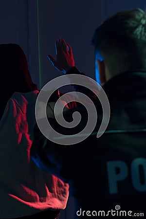 Cop pointing handgun at offender Stock Photo