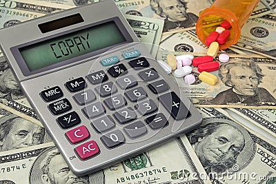 Copay text on calculator with pills Stock Photo