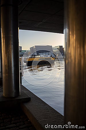 Copenhagen, Denmark - April 1, 2019: Yellow public transportation boat bus at Copenhagen on sunny day Editorial Stock Photo