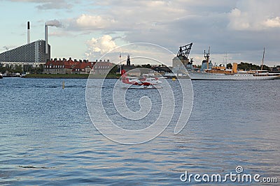 Copenhagen, Denmark - August 21,2017: Beautiful house, canoes, plane, sea and cloud at Nyhavn canal Editorial Stock Photo