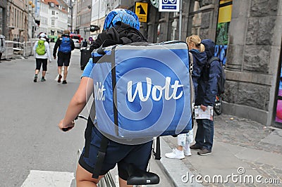 WOLT BIKER WIH BLUE WOLT BACKPACK FOR DELIVERY Editorial Stock Photo