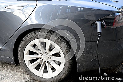 AMERICAN TESLA ELECTRIC CAR AT CELEVR CHARGE POINT Editorial Stock Photo