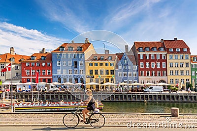 Copenhagen, Denmark - July, 2019: Copenhagen iconic view. Famous old Nyhavn port with colorful medieval houses, tourist ship and Editorial Stock Photo