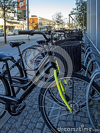 Rental bicycles parked along Carsten Niebuhrs Gade sidewalk Editorial Stock Photo