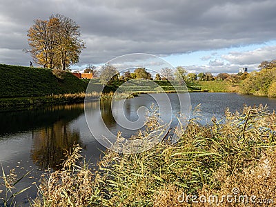 View of the waterway around a castle moat and rampart with pedestrian walkway Editorial Stock Photo