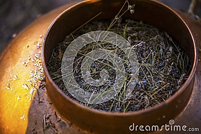 Copper bowl used for distillation to produce lavender essential oil. Stock Photo