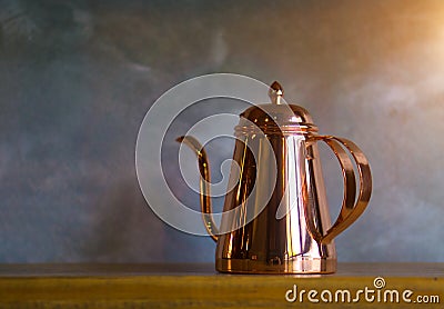 Copper coffee pots on wood shelf for home interior Stock Photo