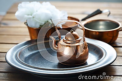 Copper old scratched vintage crockery kitchenware on the table Stock Photo