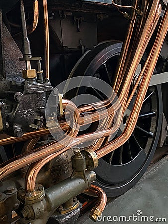 Copper pipework on a vintage steam locomotive Editorial Stock Photo