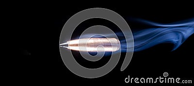 Flying bullet on black with smoke trailing behind Stock Photo