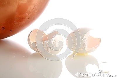 Copper pot with broken eggs isolated on white Stock Photo