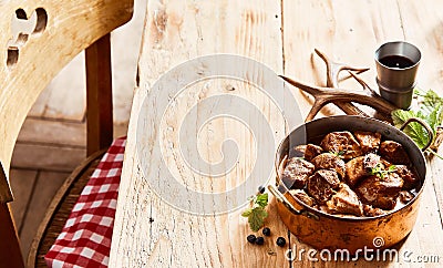 Copper pot of rich tasty deer venison goulash Stock Photo