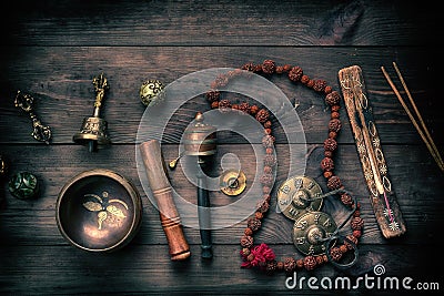 Copper singing bowl, prayer beads, prayer drum and other Tibetan religious objects for meditation Stock Photo