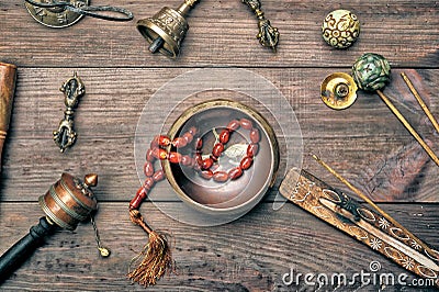 Copper singing bowl, prayer beads, prayer drum and other Tibetan religious objects for meditation Stock Photo