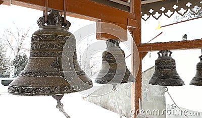 Copper snow-covered church bells orthodox church. Stock Photo