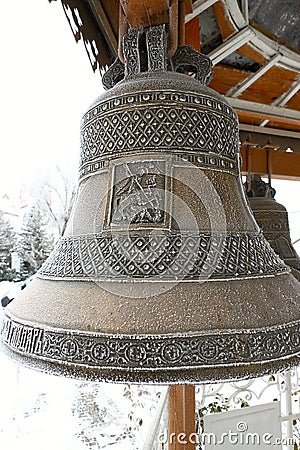 Copper snow-covered church bells orthodox church. Stock Photo