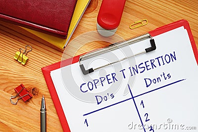 COPPER T INSERTION Do`s and Don`ts inscription on the sheet Stock Photo