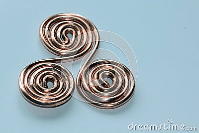 Copper Triskelion handmade from annealing copper Stock Photo